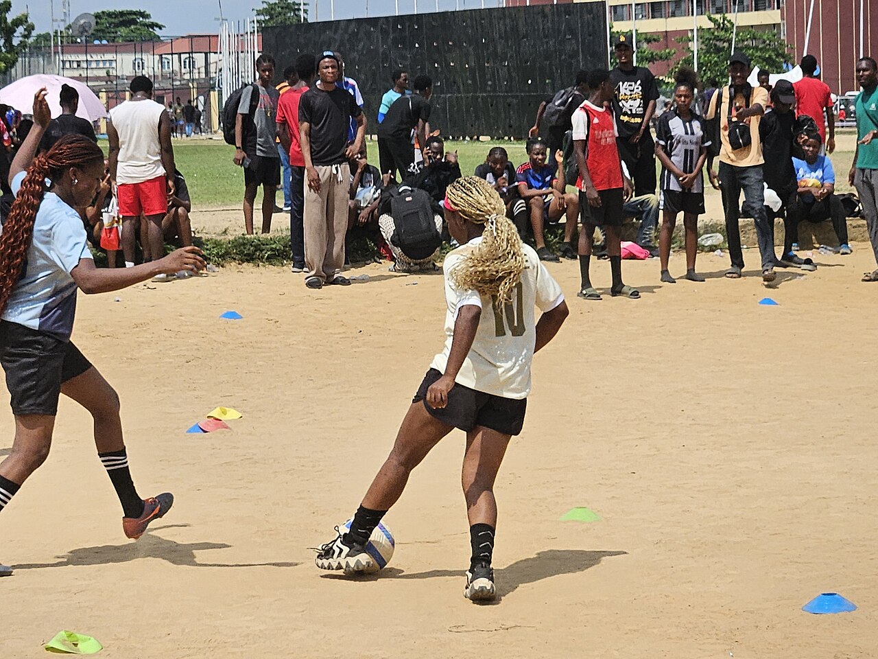 Grassroots football players competing in a tense match during the 1XCup 2026 in Lagos