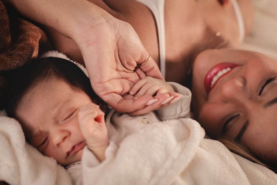 A mother holding her baby representing the diaspora naming controversy