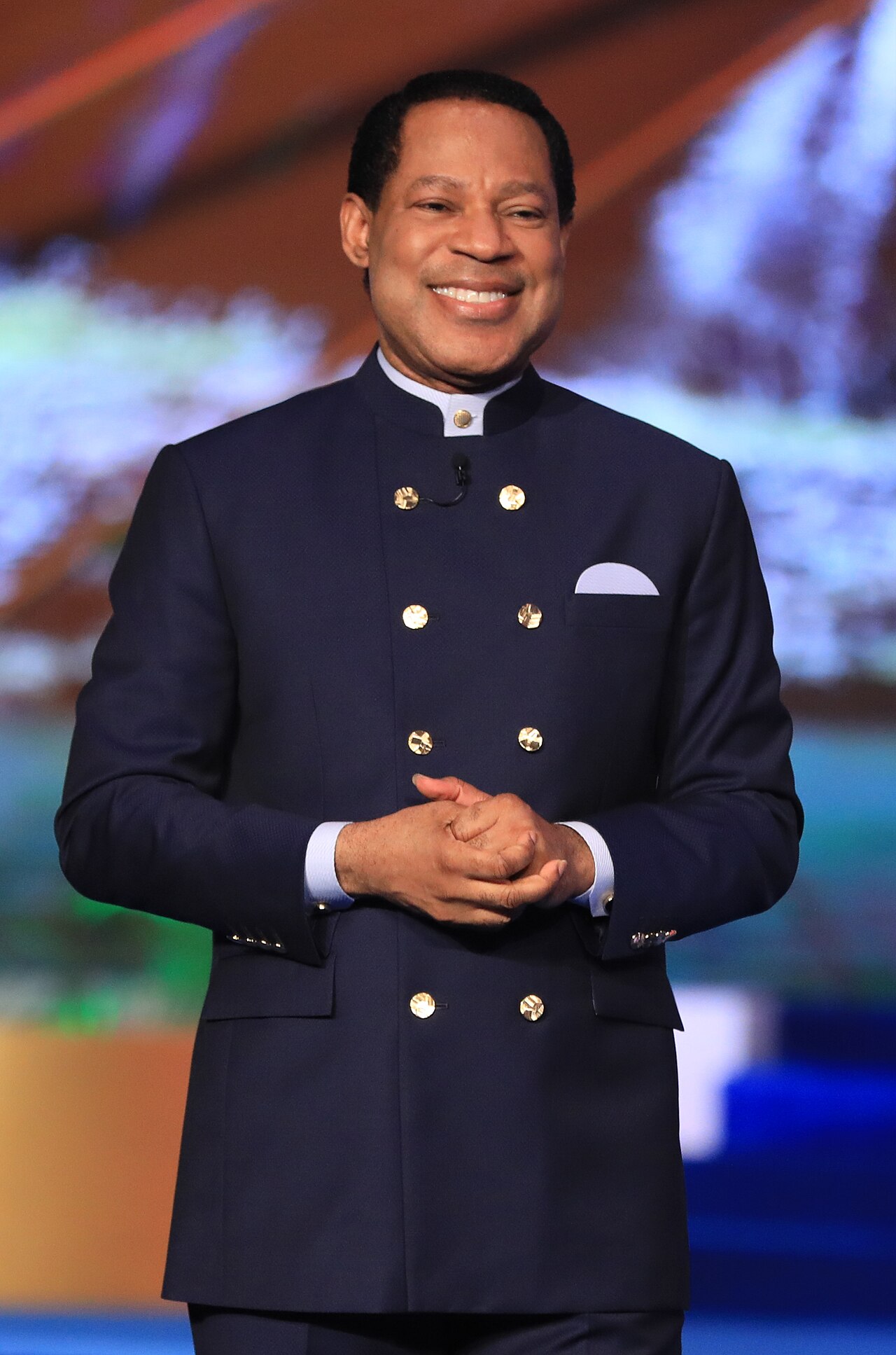 Apostle preaching behind a pulpit in a large Nigerian church