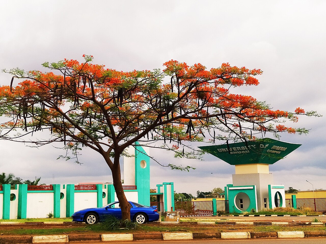 Students walking past a modern building at Lagos State University Ojo campus