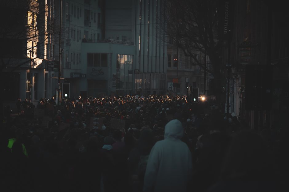 Nigerian youths discussing politics and elections in a crowded street