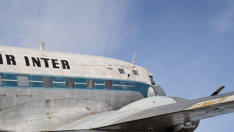 Airplane flying in the sky representing international travel and trips