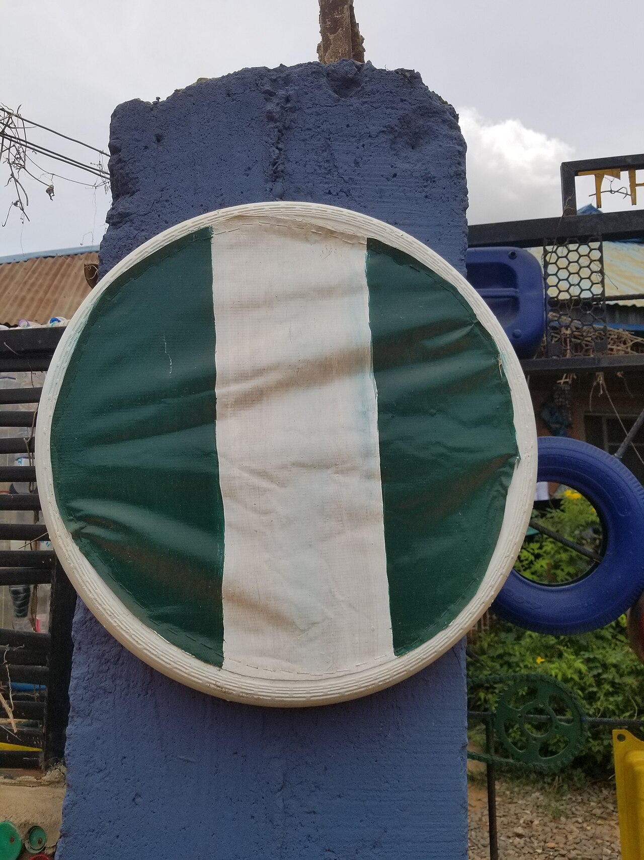 Nigerian national flag waving against a clear sky representing federal government initiatives