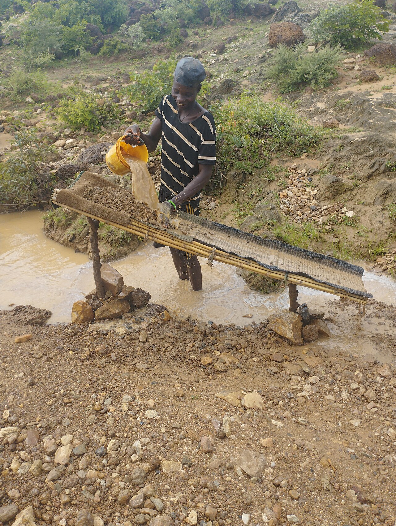 Federal government officials and miners discussing safety standards at a mining site in Nigeria