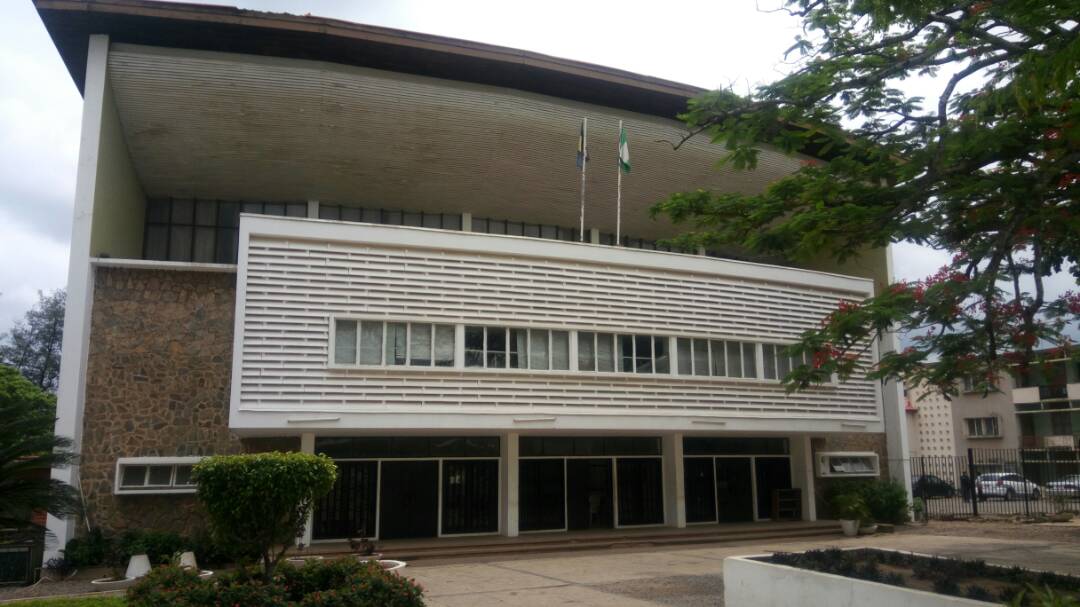Students walking past a historic building at the University of Ibadan campus in Nigeria